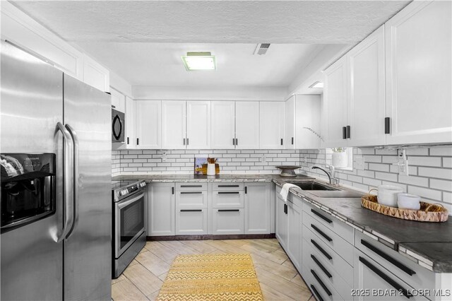 31372 Golden Wood Rd, Gravois Mills, MO 65037 - kitchen featuring white cabinetry, backsplash, appliances with stainless steel finishes, and a sink