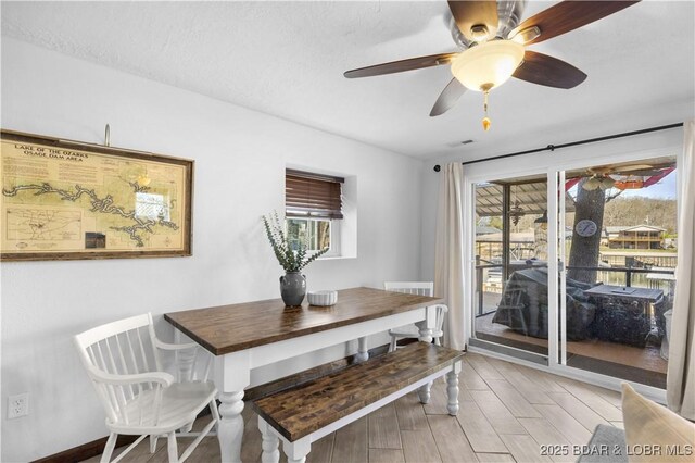 31372 Golden Wood Rd, Gravois Mills, MO 65037 - dining area featuring a wealth of natural light, light wood finished floors, baseboards, and a ceiling fan