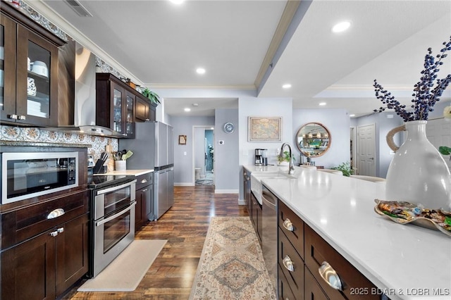 248 Palisades Condo Dr Unit 4A, Lake Ozark, MO 65049 - kitchen with stainless steel appliances, ornamental molding, dark wood-type flooring, light countertops, and dark brown cabinetry