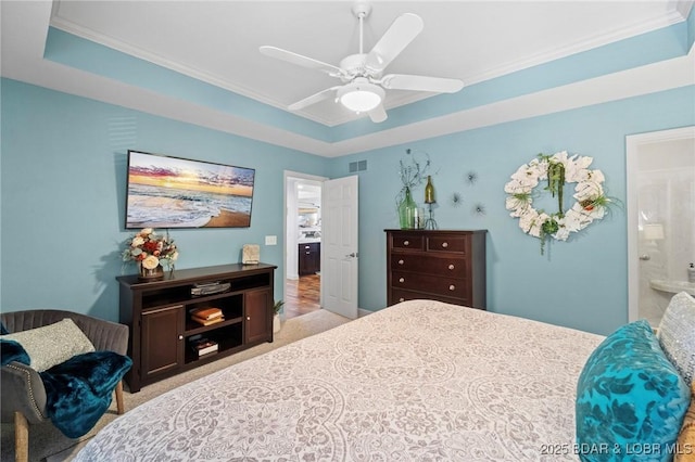 248 Palisades Condo Dr Unit 4A, Lake Ozark, MO 65049 - bedroom with a tray ceiling, ornamental molding, carpet flooring, a ceiling fan, and connected bathroom