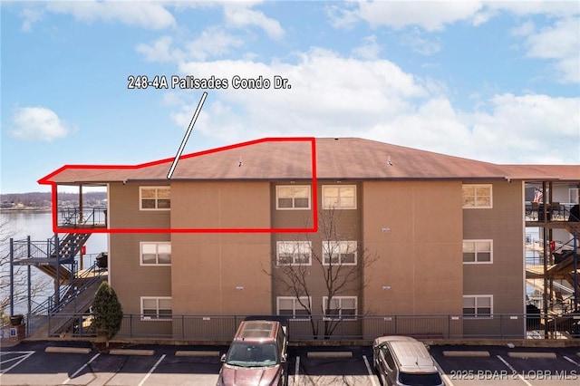 248 Palisades Condo Dr Unit 4A, Lake Ozark, MO 65049 - view of apartment building / complex featuring uncovered parking and a water view