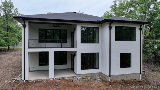 320 Via Appia Dr, Sunrise Beach, MO 65079 - rear view of house featuring a balcony, a patio, ceiling fan, roof with shingles, and stucco siding