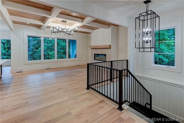 320 Via Appia Dr, Sunrise Beach, MO 65079 - stairs with a chandelier, beamed ceiling, wood finished floors, coffered ceiling, and baseboards