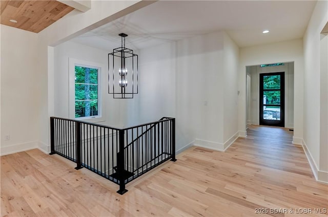 320 Via Appia Dr, Sunrise Beach, MO 65079 - stairway featuring plenty of natural light, wood finished floors, a chandelier, recessed lighting, and baseboards