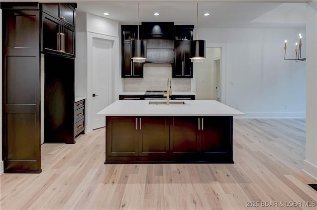 320 Via Appia Dr, Sunrise Beach, MO 65079 - kitchen with a sink, light wood-type flooring, light countertops, backsplash, and recessed lighting