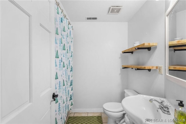 full bathroom with a sink, visible vents, toilet, and tile patterned flooring