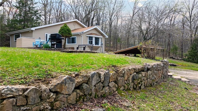 exterior space with a yard and a chimney