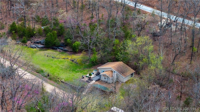 birds eye view of property with a forest view