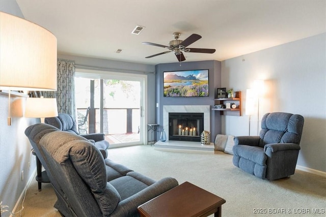 222 Park Place Ln Unit 2A, Kaiser, MO 65047 - carpeted living area with baseboards, a ceiling fan, and a fireplace