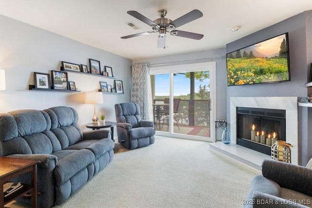 222 Park Place Ln Unit 2A, Kaiser, MO 65047 - carpeted living room with a fireplace and a ceiling fan