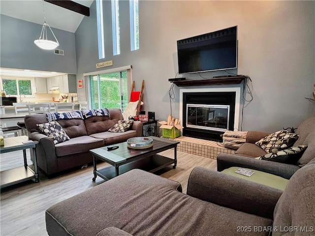 1505 Swiss Village Rd Unit A5, Osage Beach, MO 65065 - living room with wood finished floors, a tile fireplace, and high vaulted ceiling