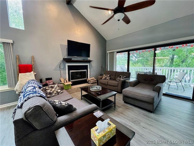 1505 Swiss Village Rd Unit A5, Osage Beach, MO 65065 - living room featuring high vaulted ceiling, wood finished floors, ceiling fan, and a glass covered fireplace