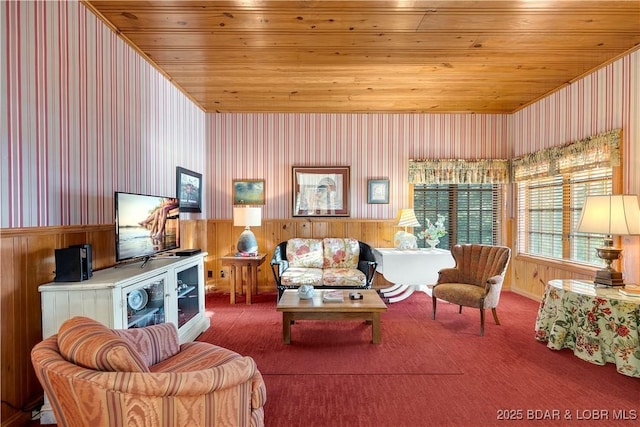 carpeted living room with wood ceiling, wallpapered walls, a wainscoted wall, and wooden walls