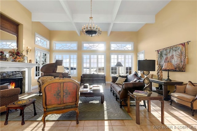 living area with beamed ceiling, a fireplace, tile patterned floors, coffered ceiling, and baseboards