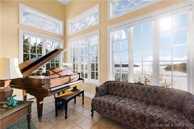 sunroom / solarium featuring a water view