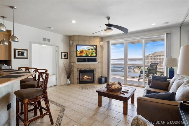 1205 Lands End Pkwy Unit 533, Osage Beach, MO 65065 - living room with a tile fireplace, light tile patterned flooring, a ceiling fan, and recessed lighting