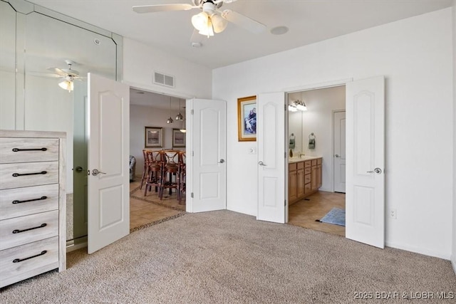 1205 Lands End Pkwy Unit 533, Osage Beach, MO 65065 - bedroom featuring light carpet, connected bathroom, and a ceiling fan