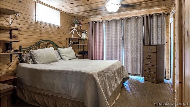 bedroom with brick floors, wood walls, and wood ceiling