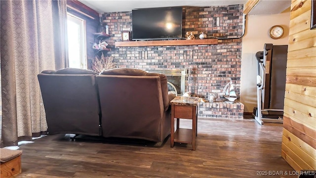 living area with wood finished floors and a fireplace