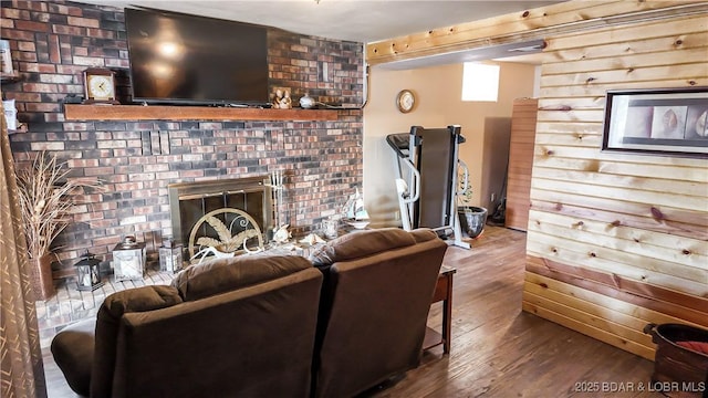 living room featuring wood finished floors and a brick fireplace