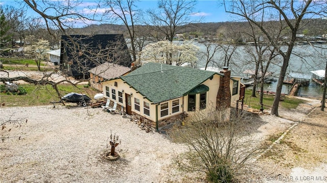 aerial view of property and surrounding area featuring a large body of water