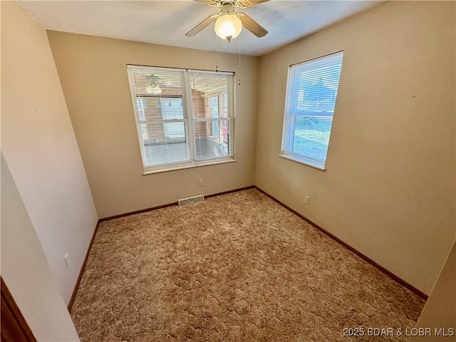 unfurnished room with baseboards, ceiling fan, and carpet flooring