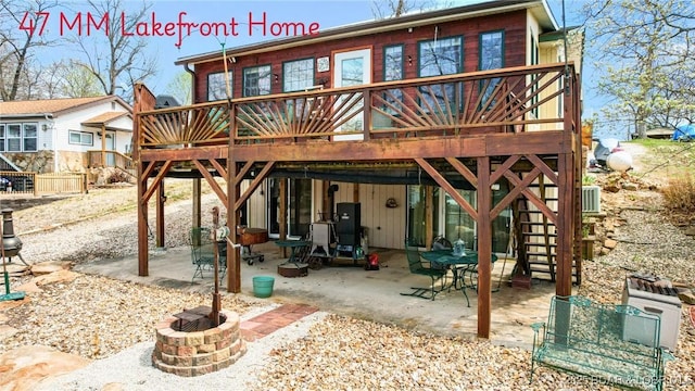 back of house featuring an outdoor fire pit, a deck, a patio area, and stairway