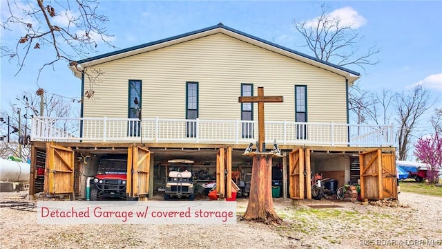 rear view of property featuring a carport, a wooden deck, and dirt driveway