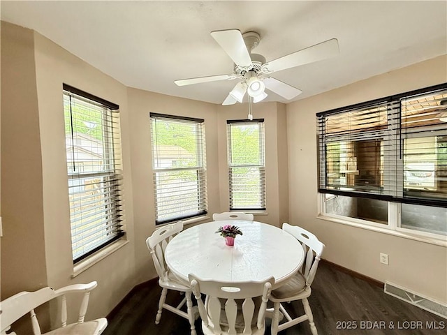dining space with dark wood-style floors, ceiling fan, and baseboards