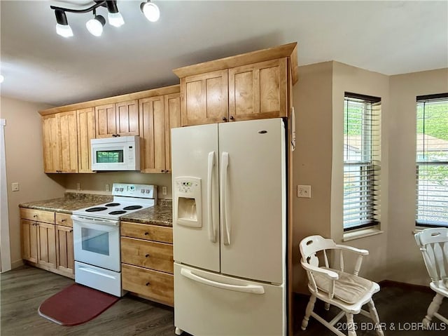 kitchen featuring white appliances, dark wood-style flooring, dark countertops, and light brown cabinetry