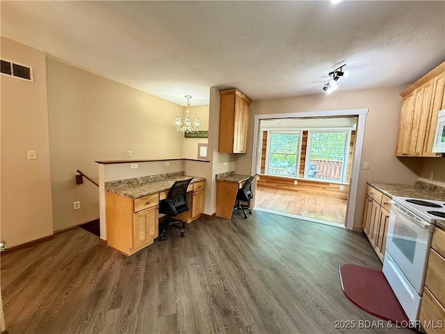 kitchen featuring white appliances, dark wood-type flooring, a desk, and baseboards