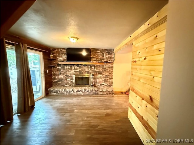 21 Ke Jo Point Rd, Gravois Mills, MO 65037 - unfurnished living room with a brick fireplace, wood finished floors, and a textured ceiling
