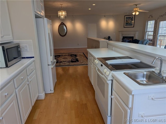 393 Crystal Springs Rd, Linn Creek, MO 65052 - kitchen featuring white appliances, light wood-type flooring, a ceiling fan, white cabinetry, and recessed lighting