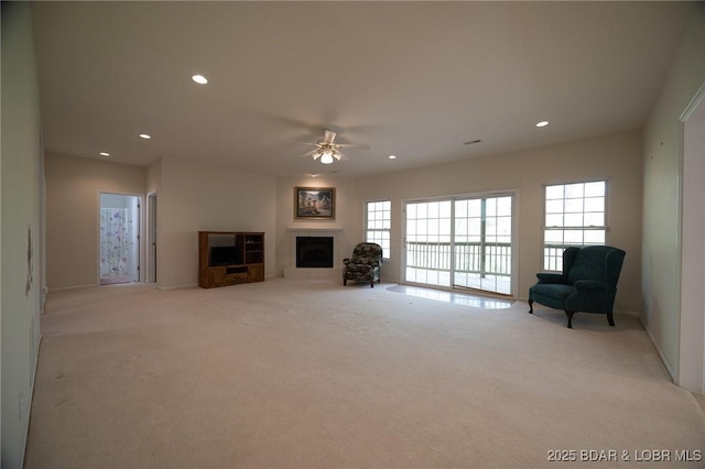 393 Crystal Springs Rd, Linn Creek, MO 65052 - living area featuring light colored carpet, a ceiling fan, a fireplace, and recessed lighting