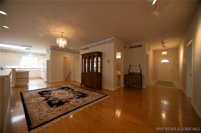 393 Crystal Springs Rd, Linn Creek, MO 65052 - foyer featuring light wood-style flooring and a chandelier