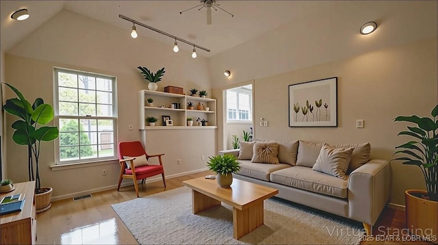 393 Crystal Springs Rd, Linn Creek, MO 65052 - living area featuring track lighting, wood finished floors, and vaulted ceiling