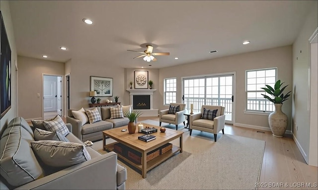 393 Crystal Springs Rd, Linn Creek, MO 65052 - living room featuring ceiling fan, light wood-type flooring, recessed lighting, and a fireplace with raised hearth