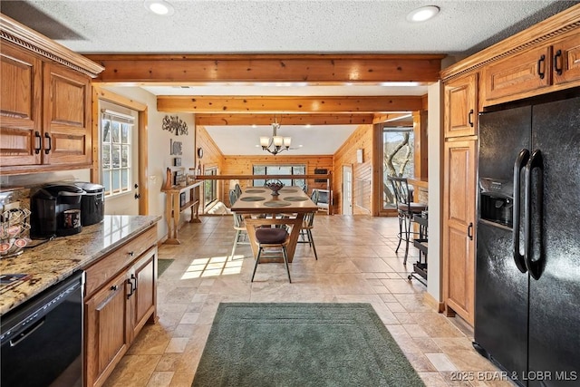 32785 Dixie Dr, Gravois Mills, MO 65037 - kitchen with black appliances, wooden walls, a chandelier, light stone countertops, and brown cabinetry