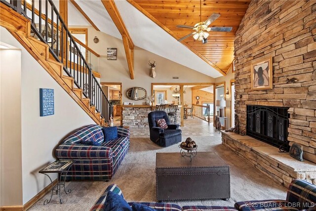 32785 Dixie Dr, Gravois Mills, MO 65037 - carpeted living area featuring a fireplace, ceiling fan, stairs, high vaulted ceiling, and wooden ceiling