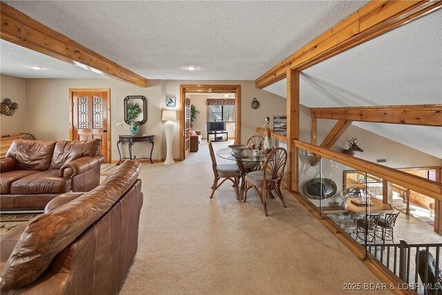 32785 Dixie Dr, Gravois Mills, MO 65037 - living room with beamed ceiling, light colored carpet, and a textured ceiling