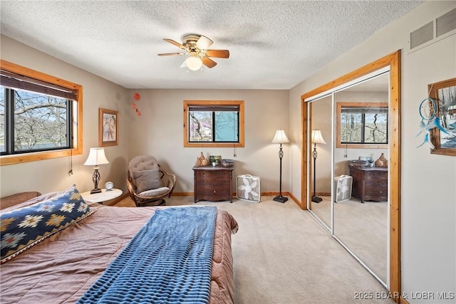 32785 Dixie Dr, Gravois Mills, MO 65037 - bedroom with multiple windows, a closet, carpet, a textured ceiling, and baseboards