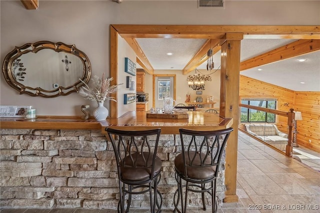 32785 Dixie Dr, Gravois Mills, MO 65037 - indoor wet bar featuring wood walls, healthy amount of natural light, recessed lighting, beam ceiling, and stone finish floors