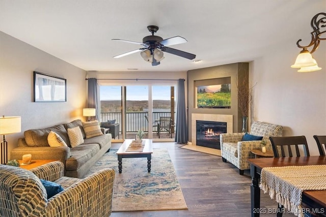 67 Cedar Heights Ln Unit 3A, Camdenton, MO 65020 - living room with ceiling fan, a fireplace with flush hearth, and dark wood-type flooring