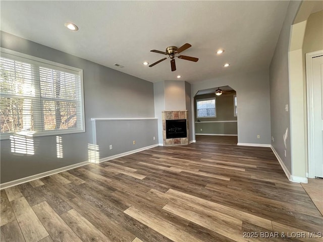 1148 Sweetwater Dr, Four Seasons, MO 65049 - unfurnished living room with baseboards, a ceiling fan, wood finished floors, and a tile fireplace