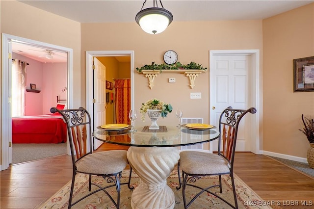 275 Flynn Rd Unit 205, Lake Ozark, MO 65049 - dining area featuring ceiling fan, wood finished floors, and baseboards