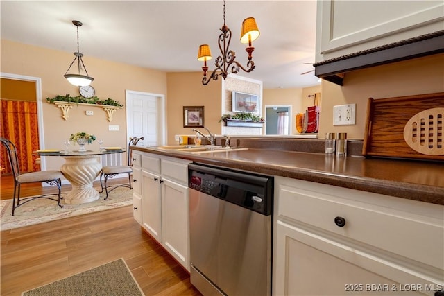 275 Flynn Rd Unit 205, Lake Ozark, MO 65049 - kitchen featuring decorative light fixtures, dishwasher, a sink, white cabinetry, and light wood finished floors