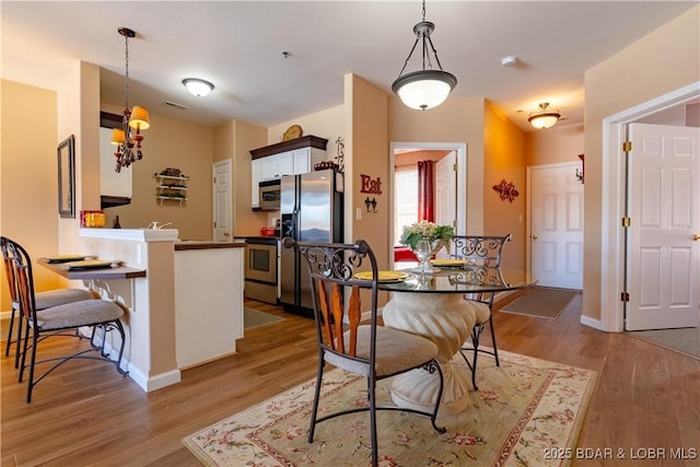 275 Flynn Rd Unit 205, Lake Ozark, MO 65049 - dining space with visible vents, baseboards, and light wood finished floors