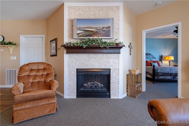 275 Flynn Rd Unit 205, Lake Ozark, MO 65049 - living area with carpet flooring, a fireplace, a ceiling fan, and visible vents