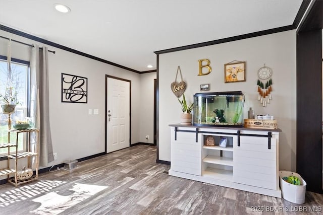 entryway featuring crown molding, wood finished floors, baseboards, and recessed lighting