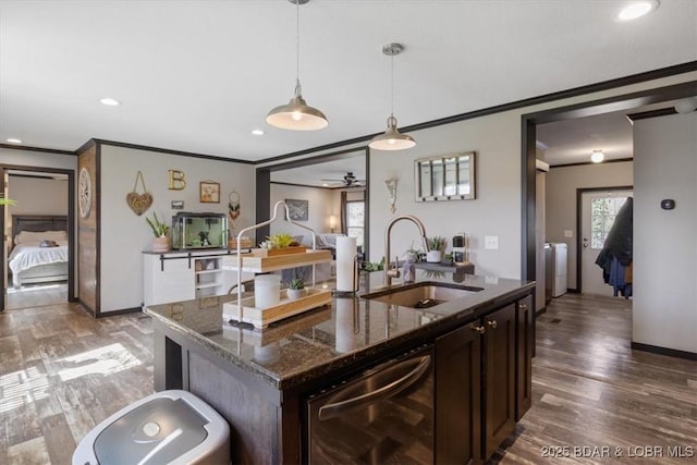 kitchen featuring a sink, ornamental molding, dishwasher, independent washer and dryer, and dark brown cabinetry